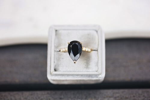 black diamond ring pear cut in a box