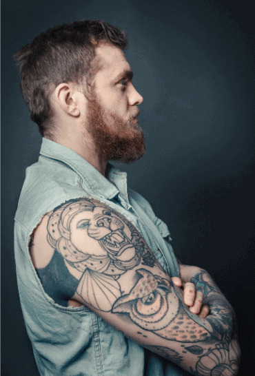 Man with owl tattoo