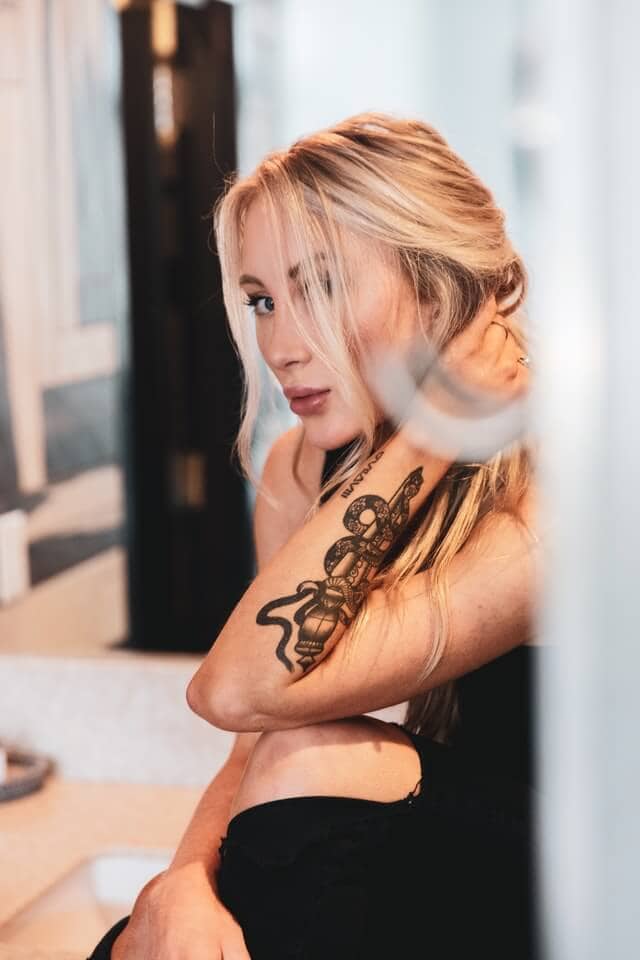 Snake tattoo on arm woman