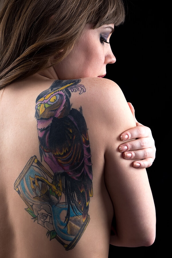 Woman with owl tattoo