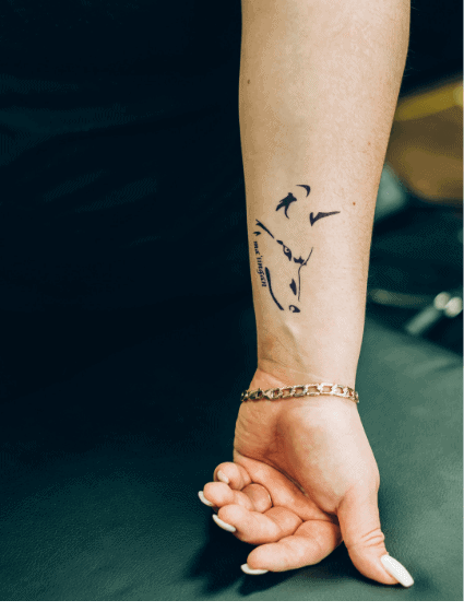 small wolf tattoo woman's arm