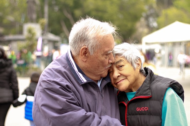 Forehead kiss old couple