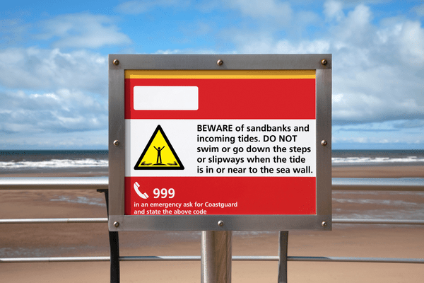 a sign in a beach with 999 numbers