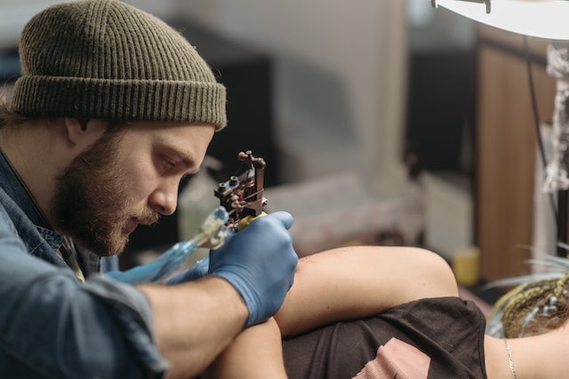man tattooing protection tattoos