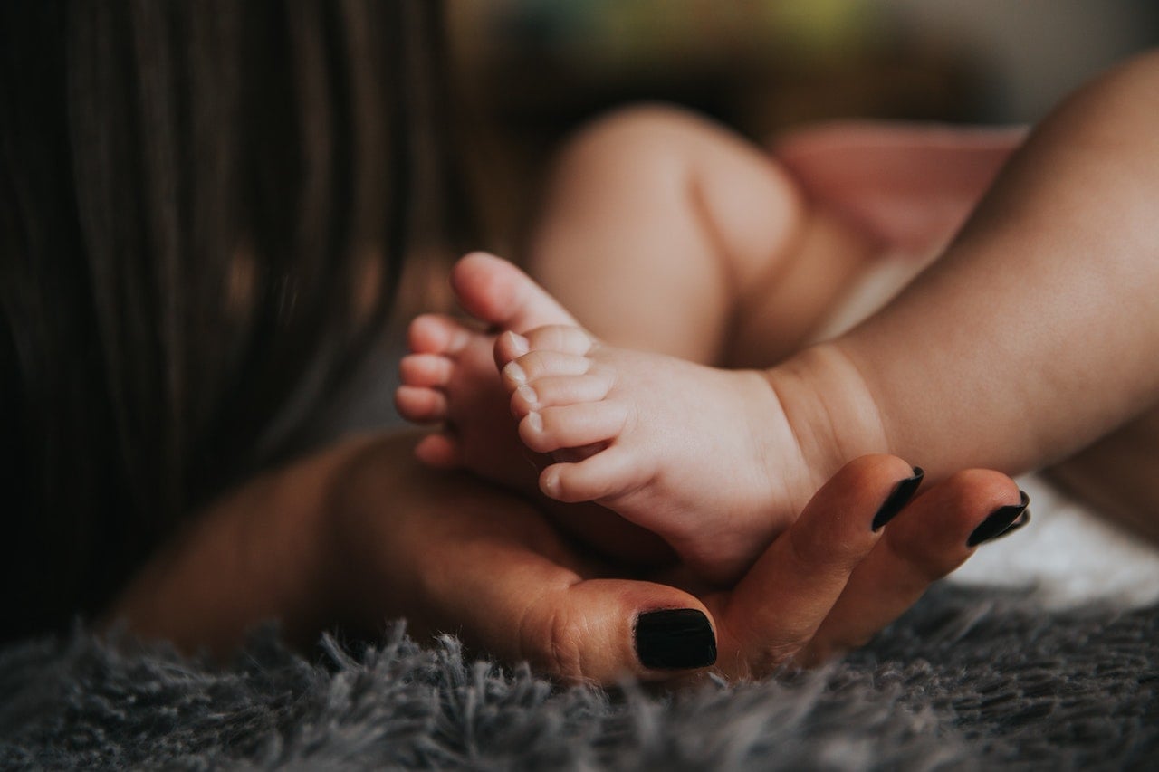Person Holding Baby's Feet 