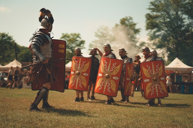 Men In Gladiator Costumes with Shields and Weapons