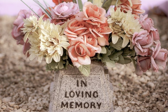 in loving memory in tomb with flowers on top