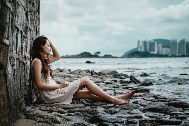 a woman sitting near the shore