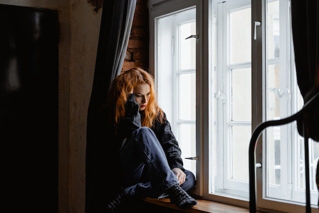 a woman sitting near the window