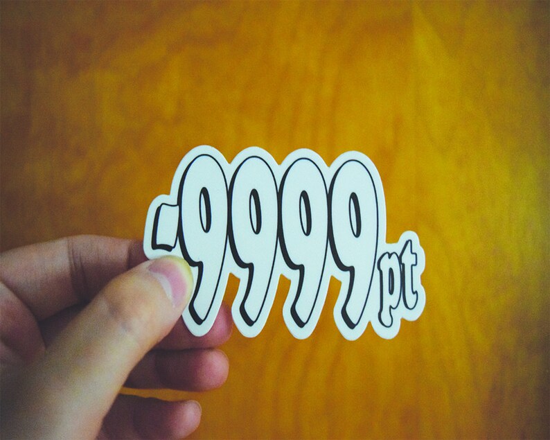 holding a 9999 angel number sticker