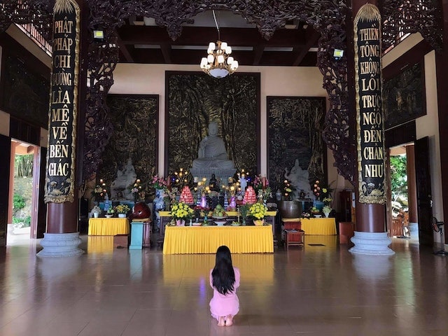 a woman praying in a temple