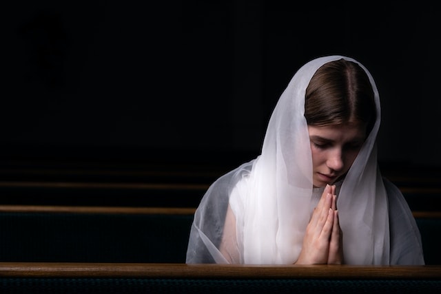 a woman praying in a church