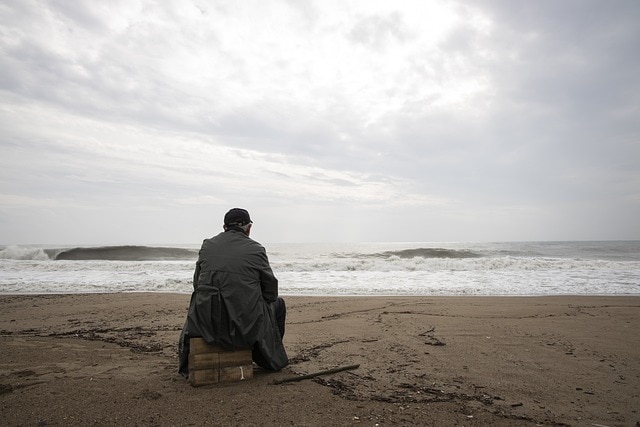 a man sitting in a beach