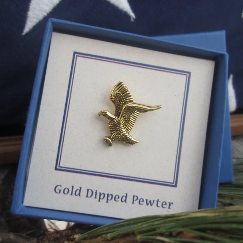 gold bald eagle lapel pin in a blue box