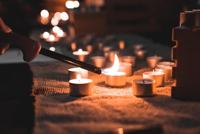 person lighting candles