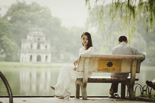 woman and a man sitting on a bench