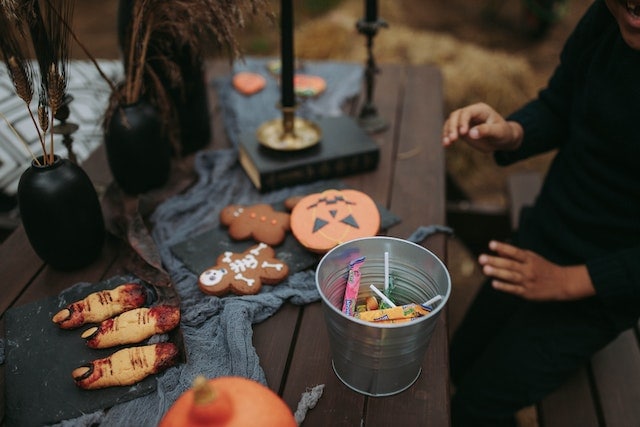 A Person Sitting at a Table with Halloween Decorations