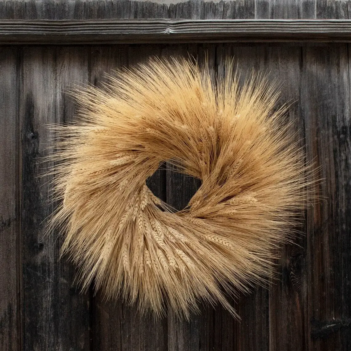 dried wheat wreath on the wooden wall